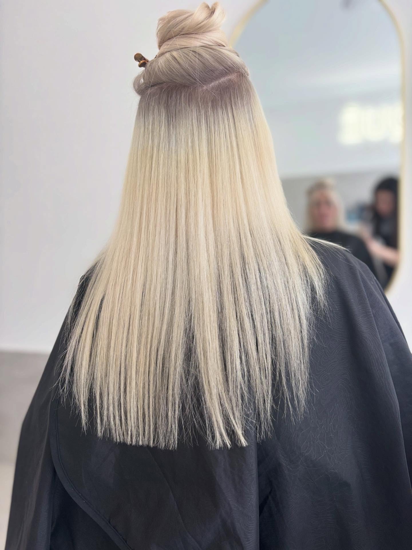 Long sleek blonde colour result, back view