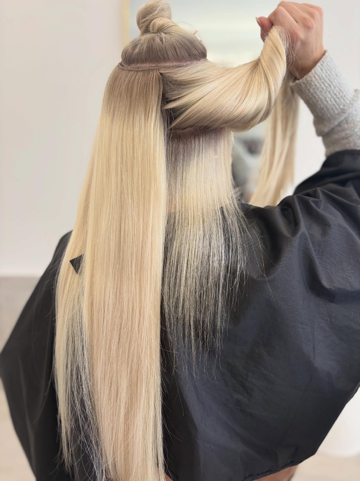 Blonde hair extensions showing added length
